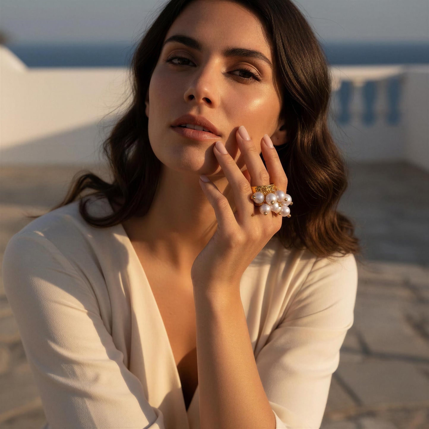 Model wearing the Ocean Pearl Bloom Ring at coastal terrace 