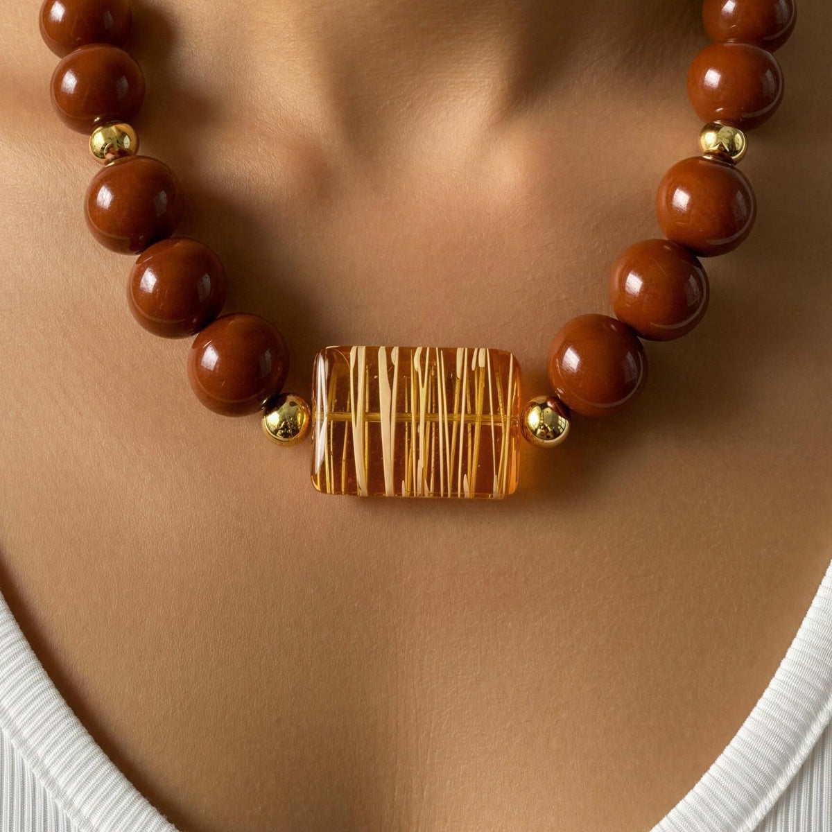 The Oranssi_Necklace from _Chica_Chica_Jewelry worn by model close up shot.