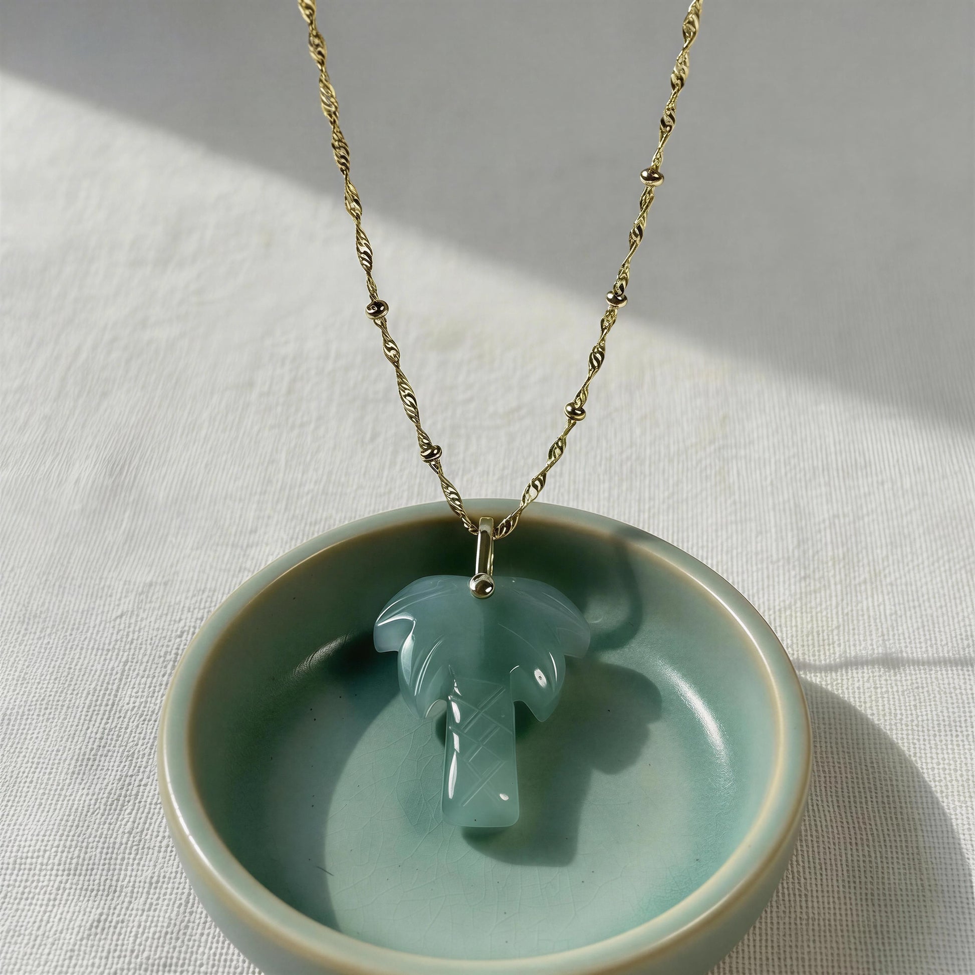 The Palma Verde Long Necklace from Chica Chica Jewelry on a light gray background
