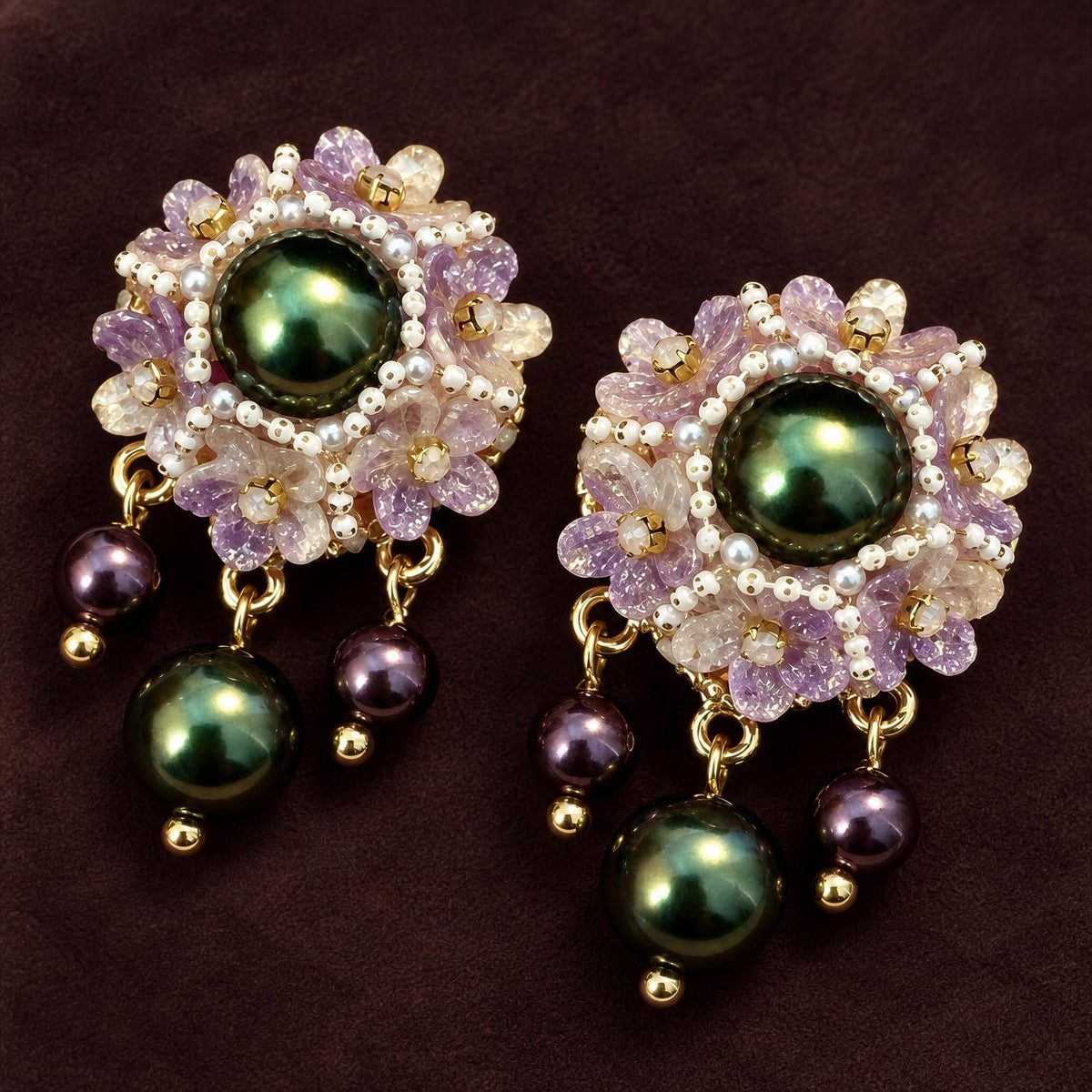The Paloma Earrings from Chica Chica Jewelry against a deep chocolate fabric. 