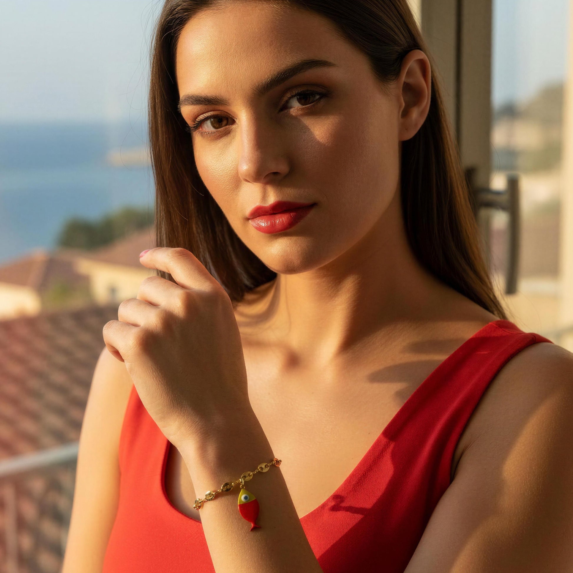 Woman in a red dress with a scenic background wearing the Pesca Roja Bracelet