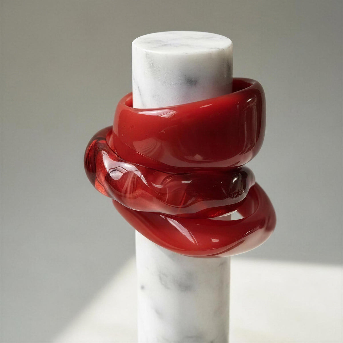The Radicchio Bangle Set- Chica Chica Jewelry set on a marble pedestal. 