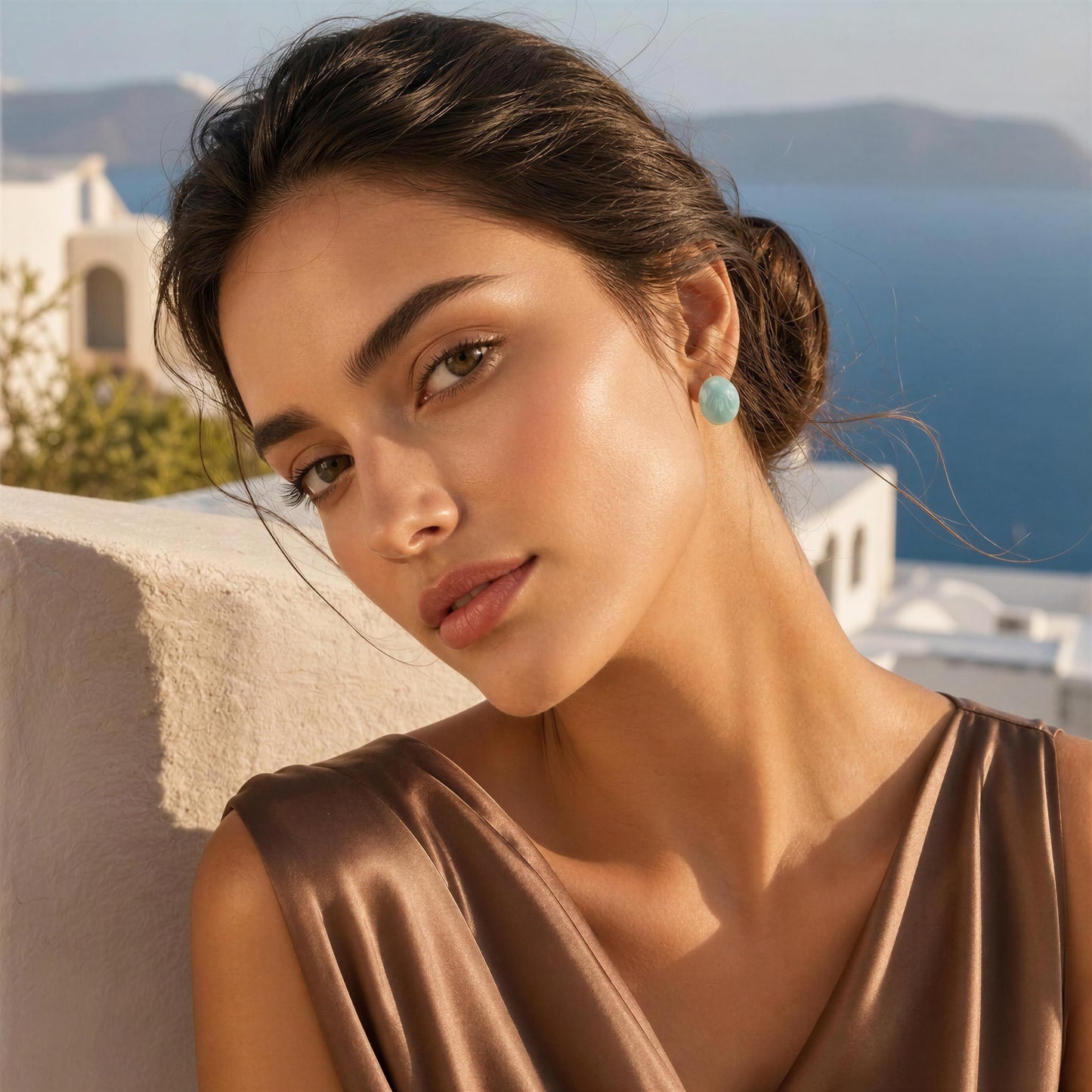Woman with a brown dress and the Rosina Studs -Aqua Glow earrings against a scenic background