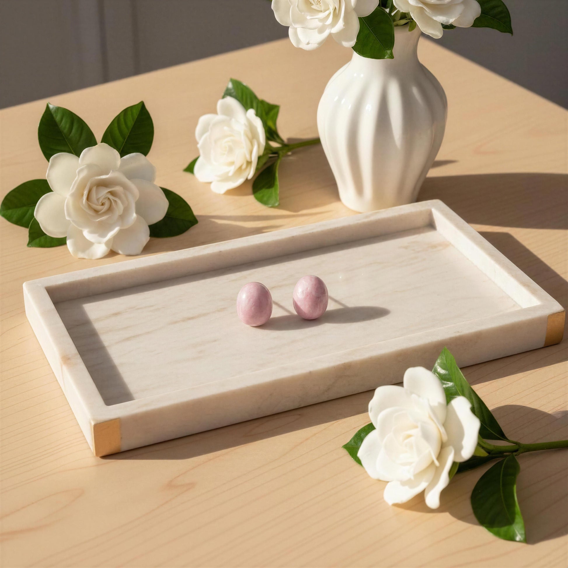 Jewelry tray with the Rosina Studs -pink earrings on a wooden surface with decorative flowers.