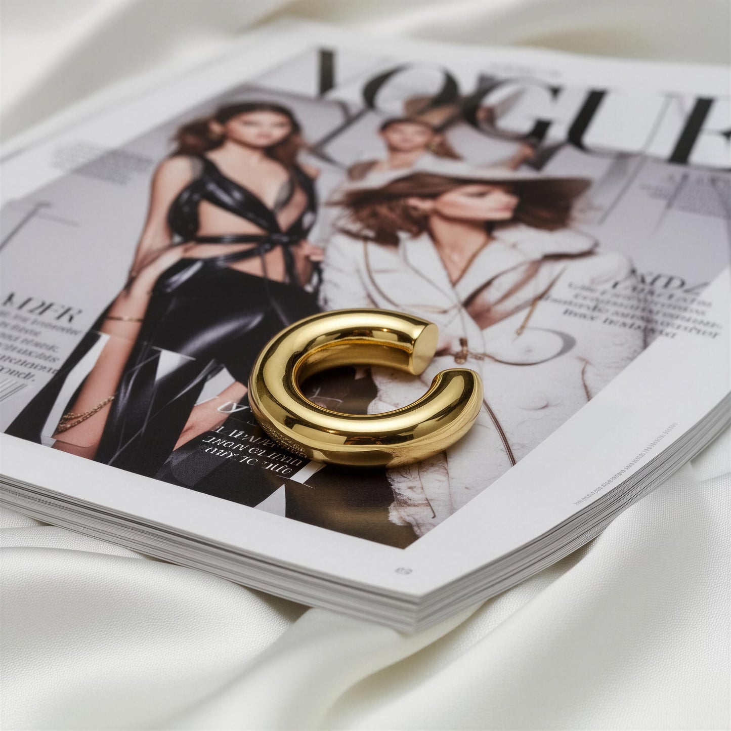 The Stellar Arc Ear Cuff earring on a Vogue magazine