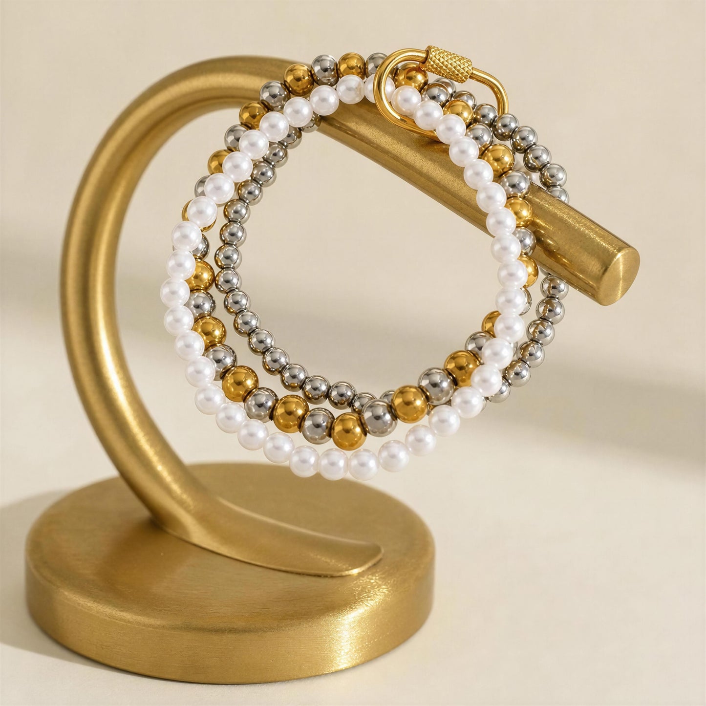 The Trio Radiance Bracelet on a gold jewelry display 