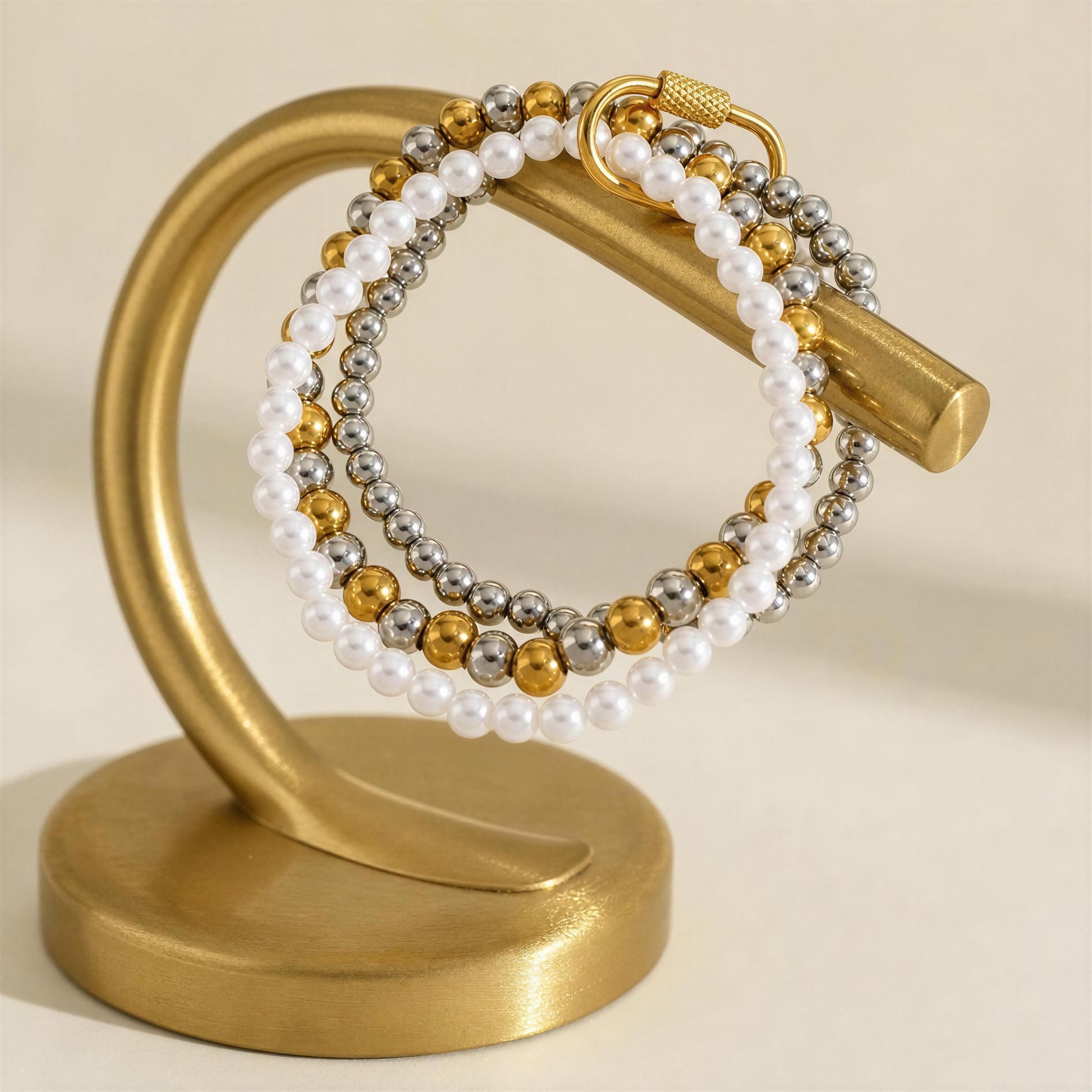 The Trio Radiance Bracelet on a gold jewelry display 