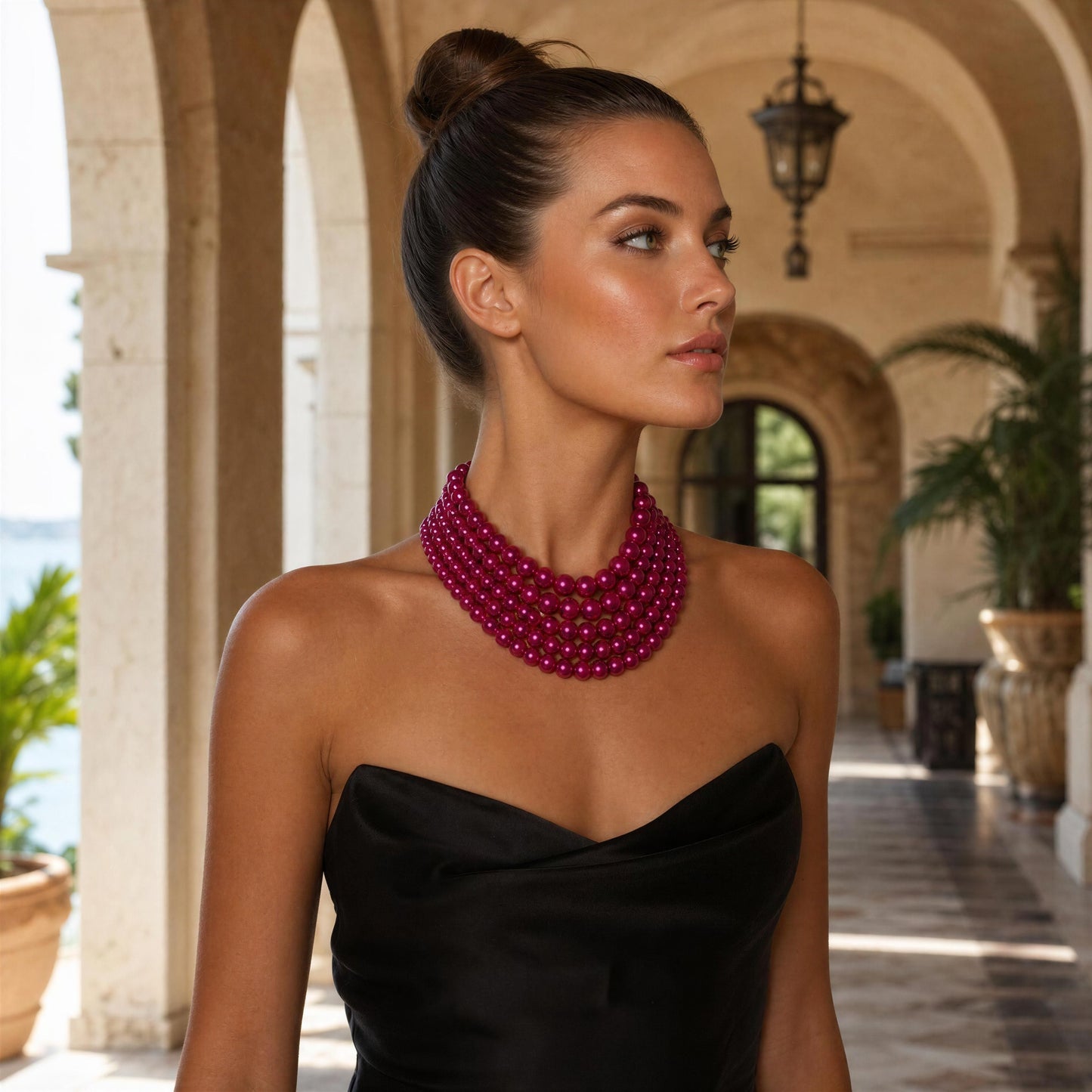 Woman wearing a black dress and the Vienna Rose Pearl Cascade Necklace in an outdoor setting