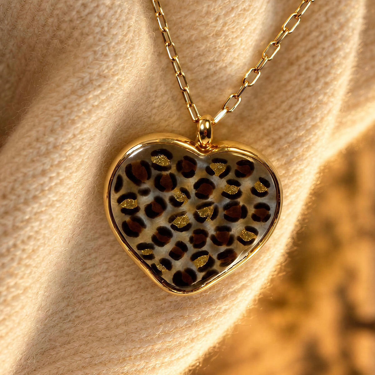 The Wild Heart Murano Necklace from  Chica Chica Jewelry against a creme color sweater.
