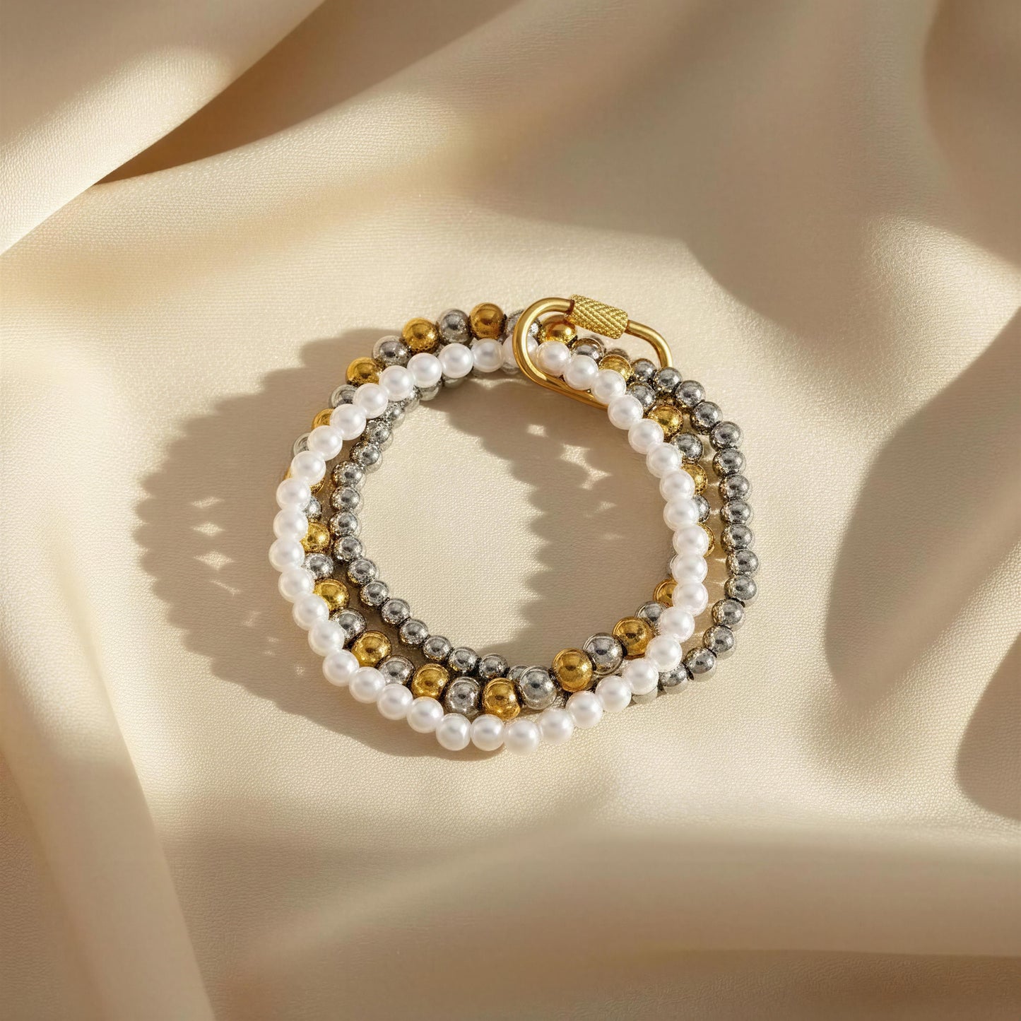 The Trio Radiance Bracelet against silk vainilla color fabric