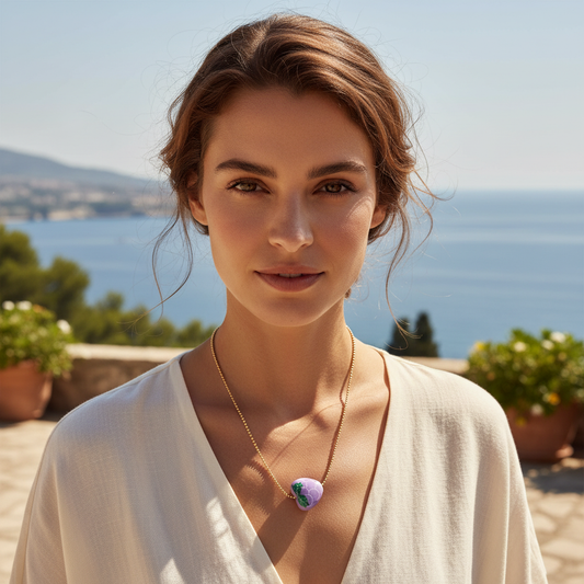 Model wearing a gold-plated Tutti Frutti grape charm necklace with a lavender grape pendant