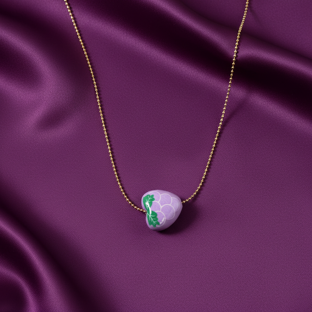 Gold-plated grape charm necklace with lavender hand-painted pendant on purple satin