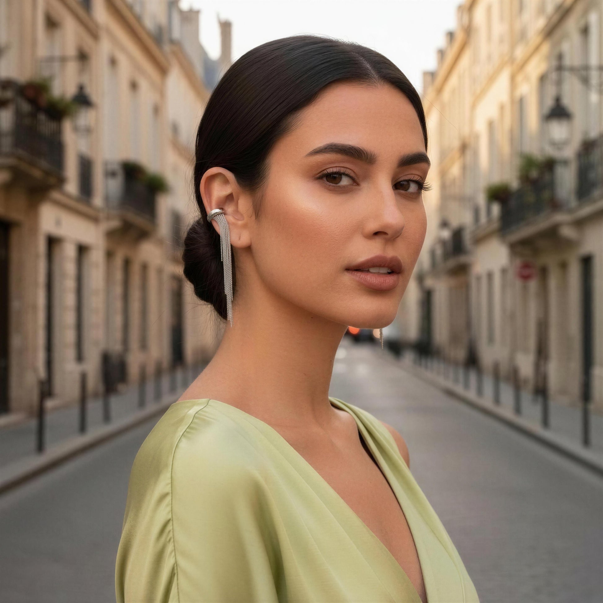 Woman wearing the Vela Silver Ear Cuff on a city street